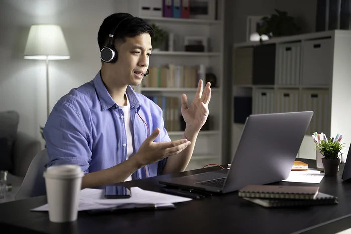 An illustrative adult online lesson with a headset and laptop