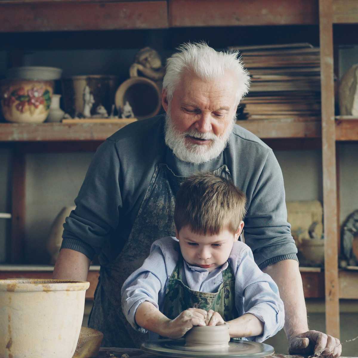 young child learning pottery